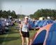 Susan G. Komen standing next to a tent
